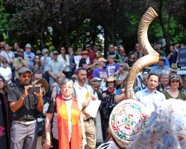 Rabbi Ariel Stone sounds the shofar at a gathering of the Interfaith Clergy Resistance last August. 