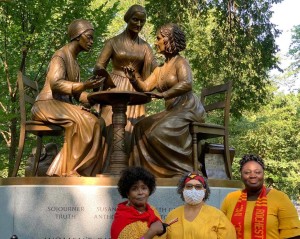 Women in front of the statue.